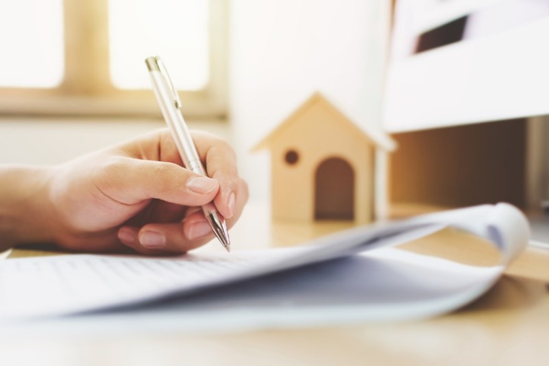 Mortgage advisor signing a form